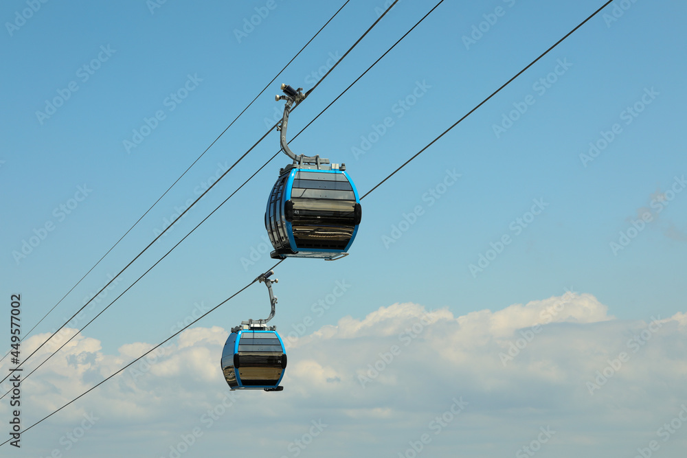 Cable car cabins against amazing sky and clouds. Cableway, green transportation. Cable car cabins against amazing sky and clouds. Cableway, green transportation.