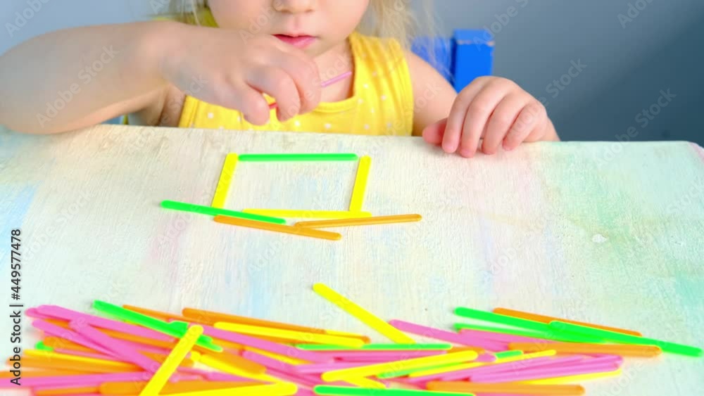 smart little child, girl 2 years plays with educational toy, learns colors, builds houses from counting sticks, concept childhood, early training of child, development of fine motor skills, thinking smart little child, girl 2 years plays with educational toy, learns colors, builds houses from counting sticks, concept childhood, early training of child, development of fine motor skills, thinking