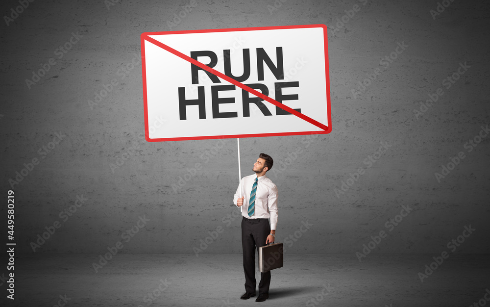 business person holding a traffic sign business person holding a traffic sign