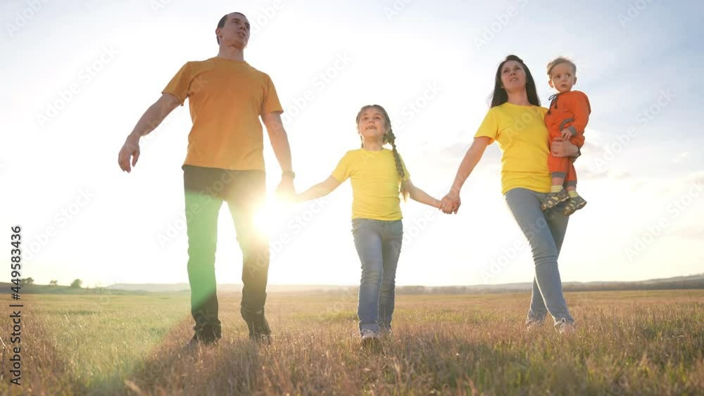 people in the park. happy family a silhouette walk at sunset. mom dad and daughters walk holding hands in park. happy family kid dream concept. parents and fun children walking fun back silhouette people in the park. happy family a silhouette walk at sunset. mom dad and daughters walk holding hands in park. happy family kid dream concept. parents and fun children walking fun back silhouette