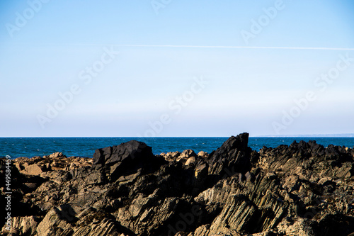 Rugged basalt dykes overlooking the Irish sea horizon