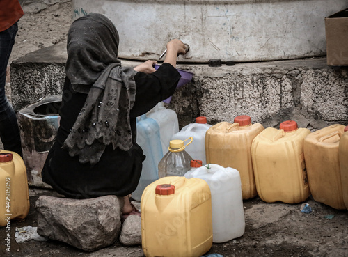 A Yemeni girl fetches water due to the water crisis in the city of Taiz