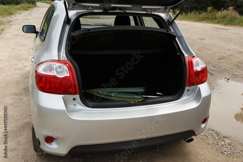 Silver color car with an open trunk