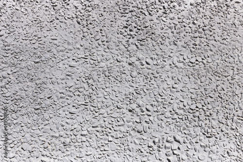 Stone concrete wall of gray color, the background, close up