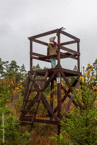 Girl climbed up in a hunting tower