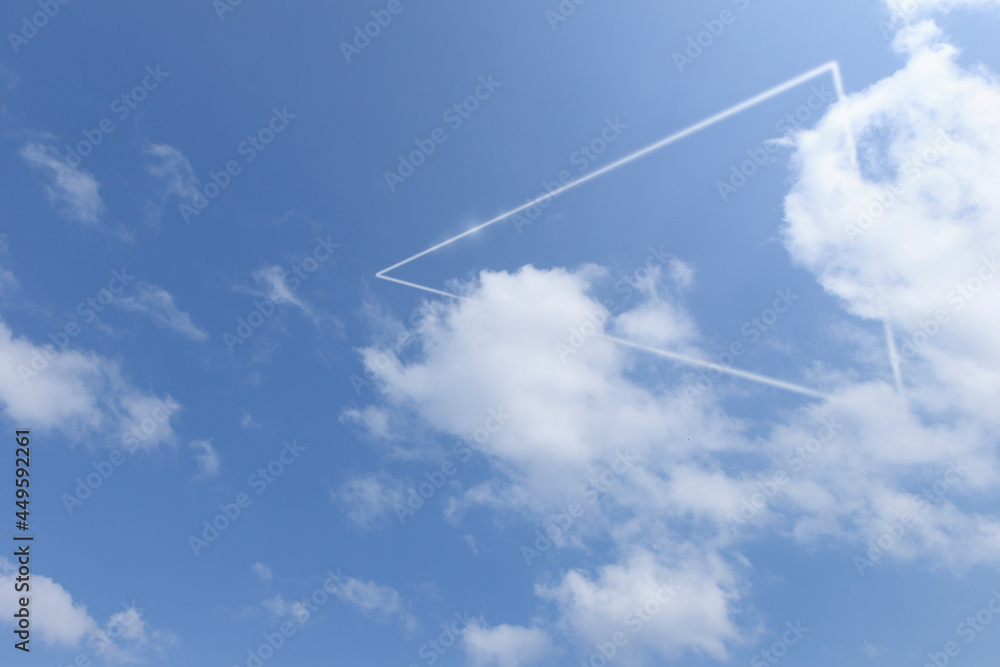 White triangle glowing around the clouds against blue sky. Abstract natural background. White triangle glowing around the clouds against blue sky. Abstract natural background.