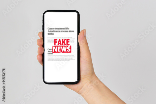 Fake news concept reading news media technology on smartphone just Fake