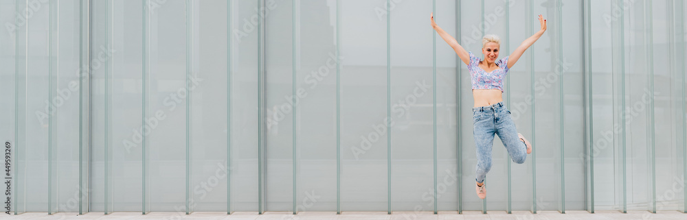 Young caucasian woman outdoor jumping celebrating success feeling free - cropped advertising banner