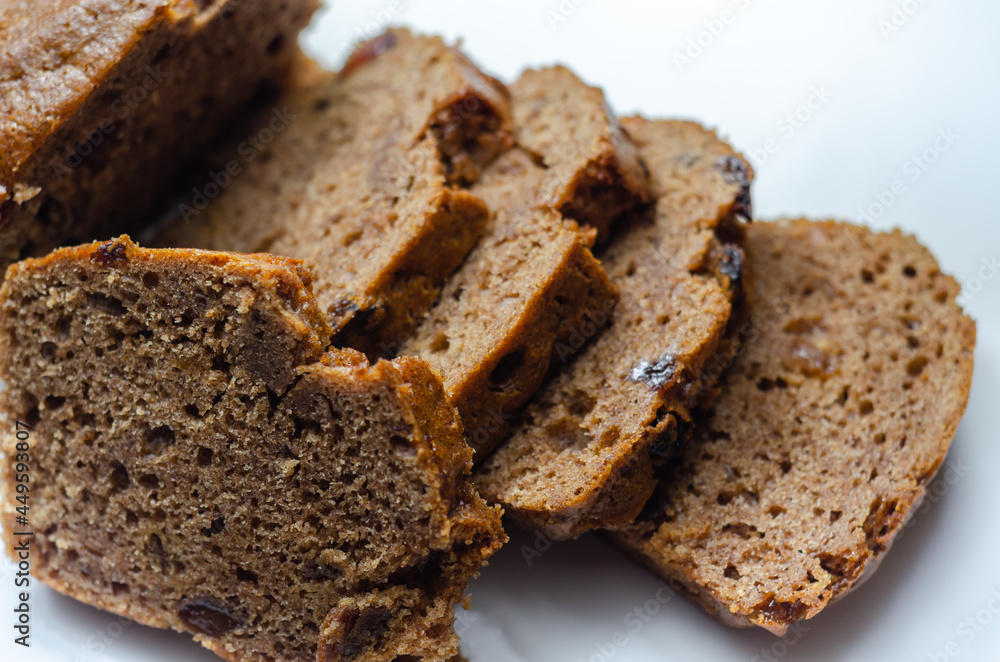 Freshly made spiced fruit loaf cake on the white background Freshly made spiced fruit loaf cake on the white background