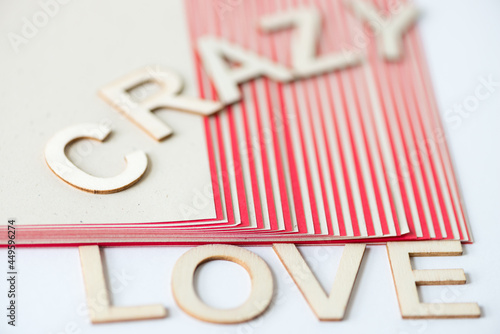 the expression "crazy love" in san serif capital letters on a striped background - close up using a macro lens - shallow depth of field (subjective focusing)