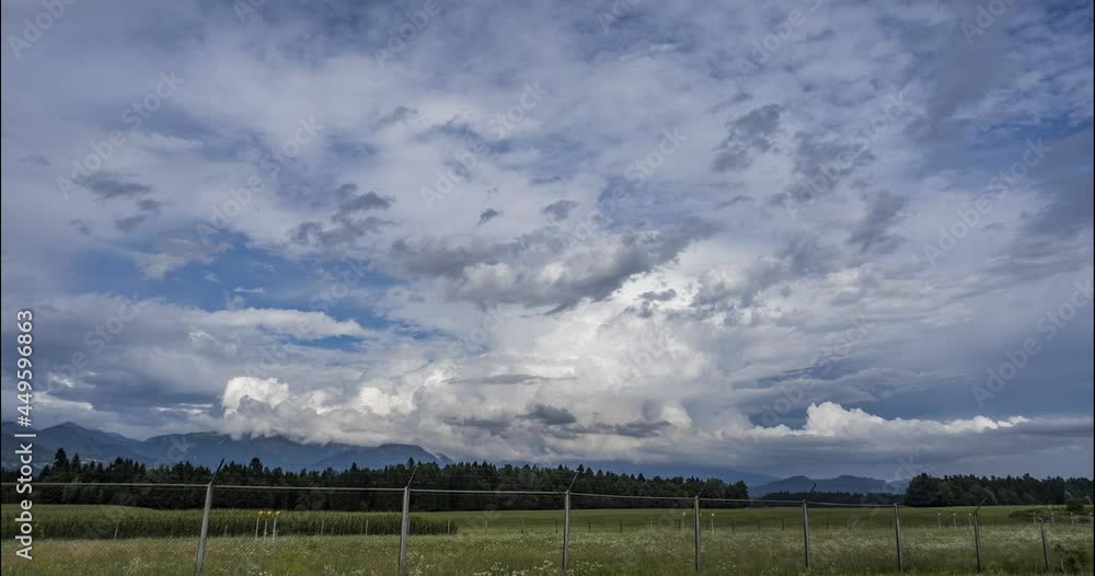 Time lapse of clouds moving over meadows, forest and mountains. Ljubljana airport fence in the foreground. Countryside grassland field. Static shot Time lapse of clouds moving over meadows, forest and mountains. Ljubljana airport fence in the foreground. Countryside grassland field. Static shot