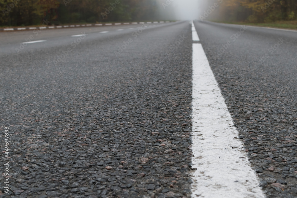 Paved road on an autumn foggy morning Paved road on an autumn foggy morning