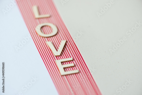 Принти на полотні the word love on a pile of plain and striped paper background