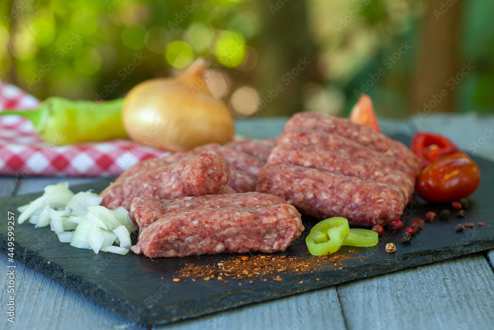 Cevapi - minced meat with spices ready for the grill. Traditional Balkan food..
