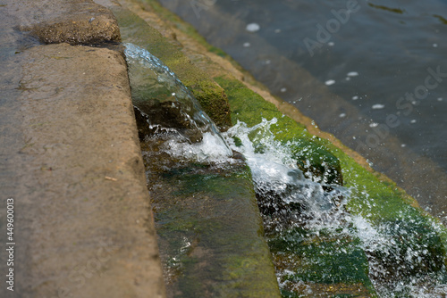 water flowing over a stepped weir into the river below