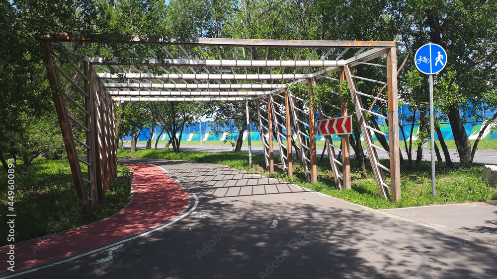 Fototapeta premium Cycle Lane-bike Path With A Wooden Fence With Signs, In Summer, Afternoon
