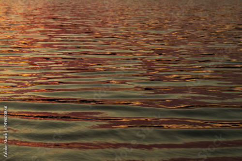 reflected sun rays on sea water. Glare on the water Natural abstract background of sea water.. © M.V.schiuma