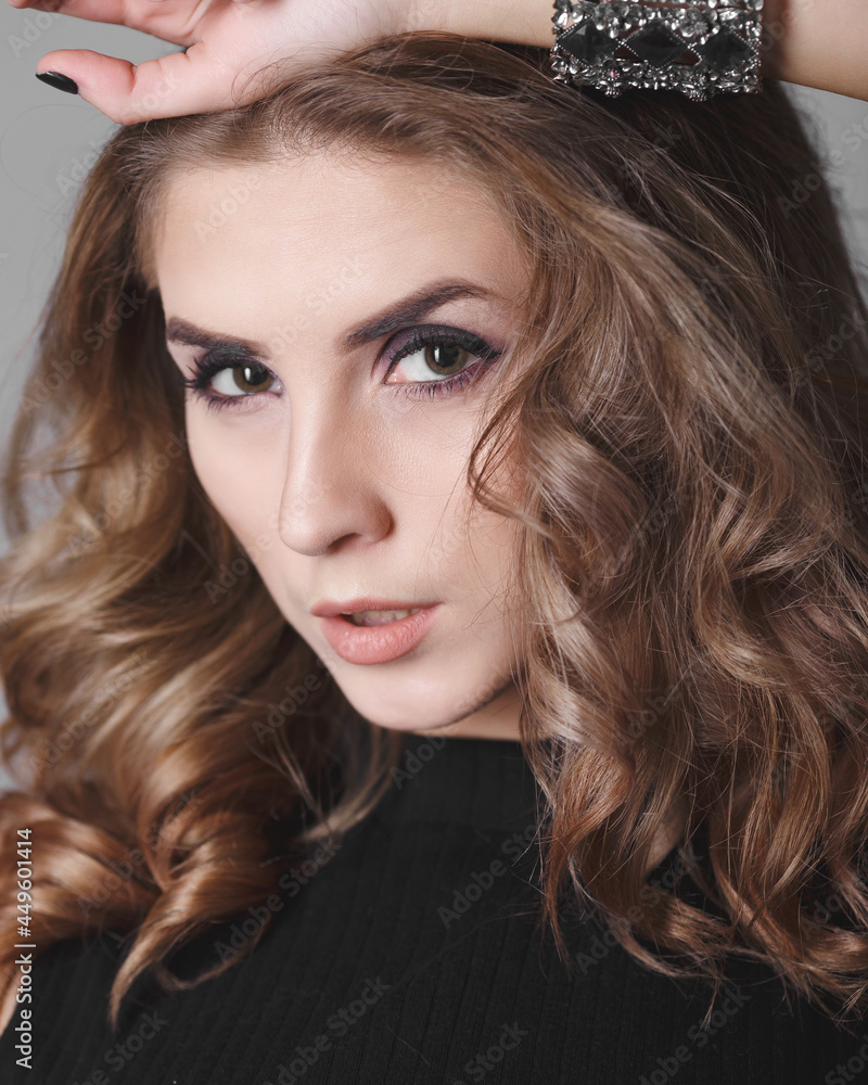 Obraz premium Fashion portrait. Studio photo on a gray background. Young pretty model.