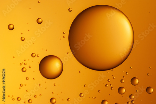 Abstract background with water drops on the glass. The concept of a natural cosmetic product serum and gel.