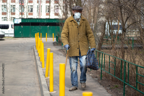 An old man in Russia. A man with a walking stick.