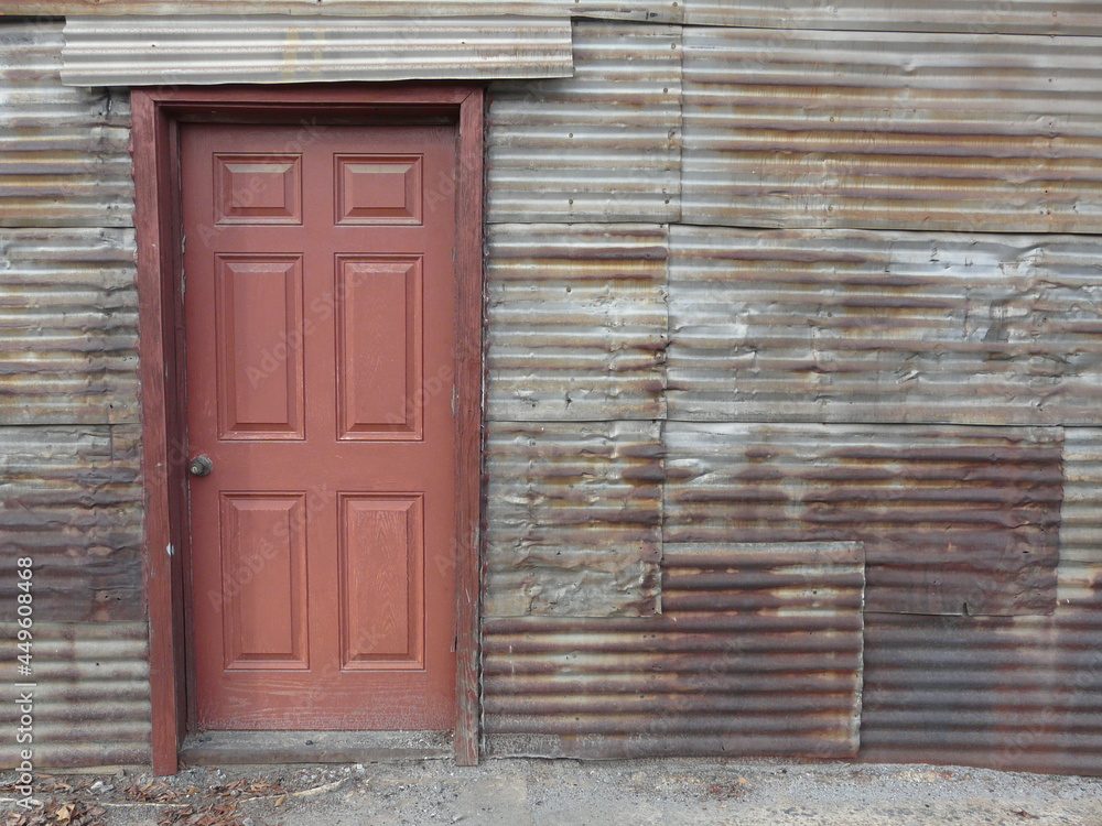 Old door on a tin sheet wall