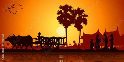country life of Asia farmer ride cart to go to do work while monk receive food on sunrise time,silhouette style