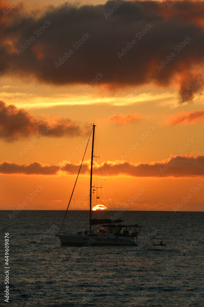 boat at sunset on water in fiji