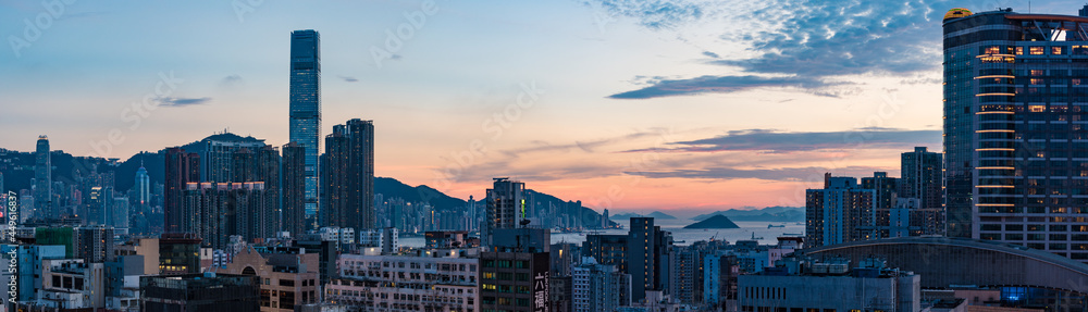 Hong Kong / China - July 2017: Ultra wide image of Hong Kong cityscape at dusk. Hong Kong / China - July 2017: Ultra wide image of Hong Kong cityscape at dusk.