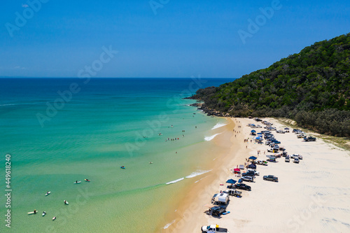 4WD vehicles and surfers at Double Island Point on a sunny day © Zstock