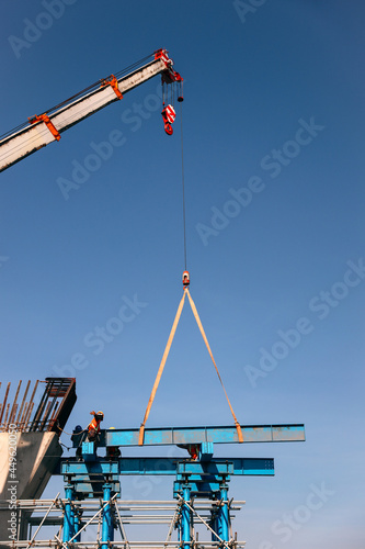 Industrial Crane lifting steel frame in construction site