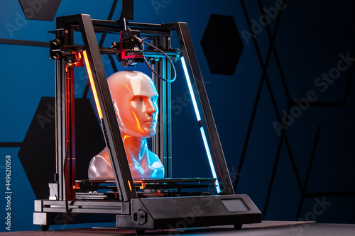 Obraz na płótnie 3D printer at work. 3d printer prints head, advertising photo blue and orange light. Copy space w salonie