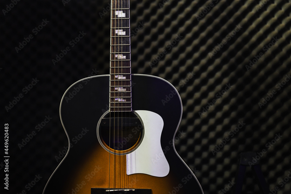 Acoustic guitar standing in the recording studio