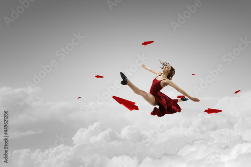 Female dancer against sky b...