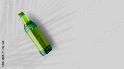Top up view green beer bottle with blank yellow template isolated on grey background. beer fiesta concept.
