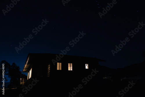 house at night with the backdrop of stars