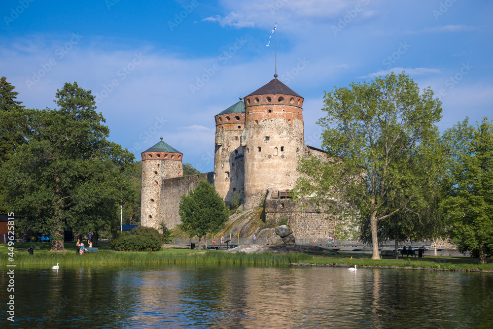 The old fortress of Olavinlinna (Olafsborg) in the summer landscape on a sunny day. Savonlinna, Finland