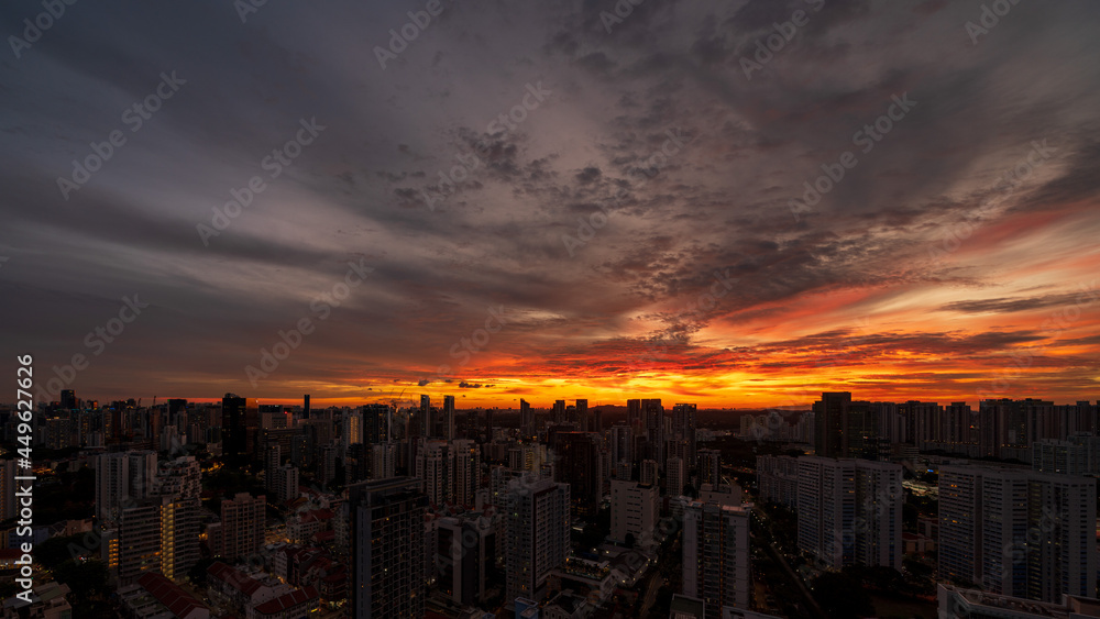 Singapore skyline with burning sunset cloud.