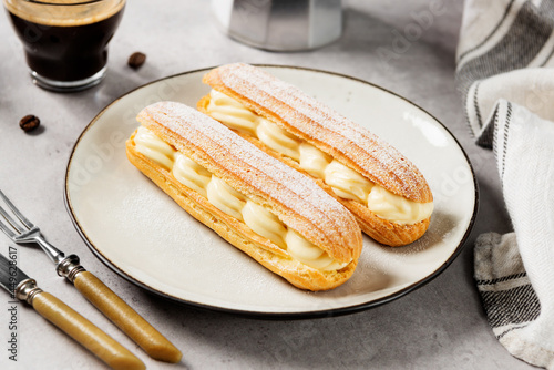 Fotografie Traditional french eclairs filled with vanilla cream and powdered sugar