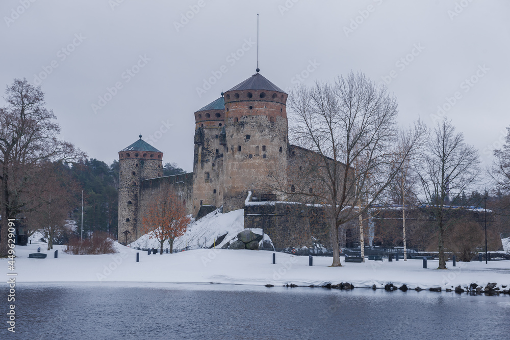 View of the ancient Olavinlinna fortress on a cloudy March day. Finland, Savonlinna