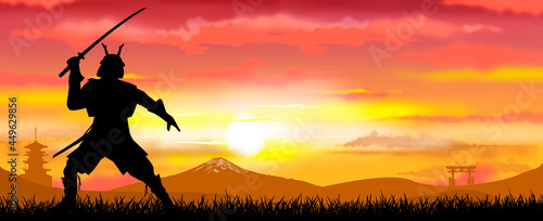 Samurai warrior with sword dressed in armor. Japanese samurai warrior with a sword at sunset. A man stands with a sword in his hands against the backdrop of a sunny sunset