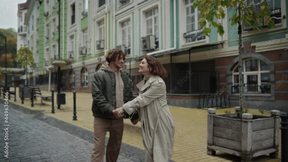 Affectionate couple kissing on city street. Man and woman enjoying each other. Affectionate couple kissing on city street. Man and woman enjoying each other.