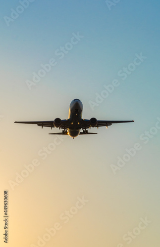 airplane silhouette in the sky under sunset