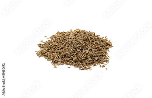 Pile of brown cumin seeds on isolated white background