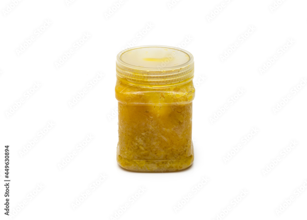 Herbal medicine bottle with brown garlic paste on an isolated white background Herbal medicine bottle with brown garlic paste on an isolated white background