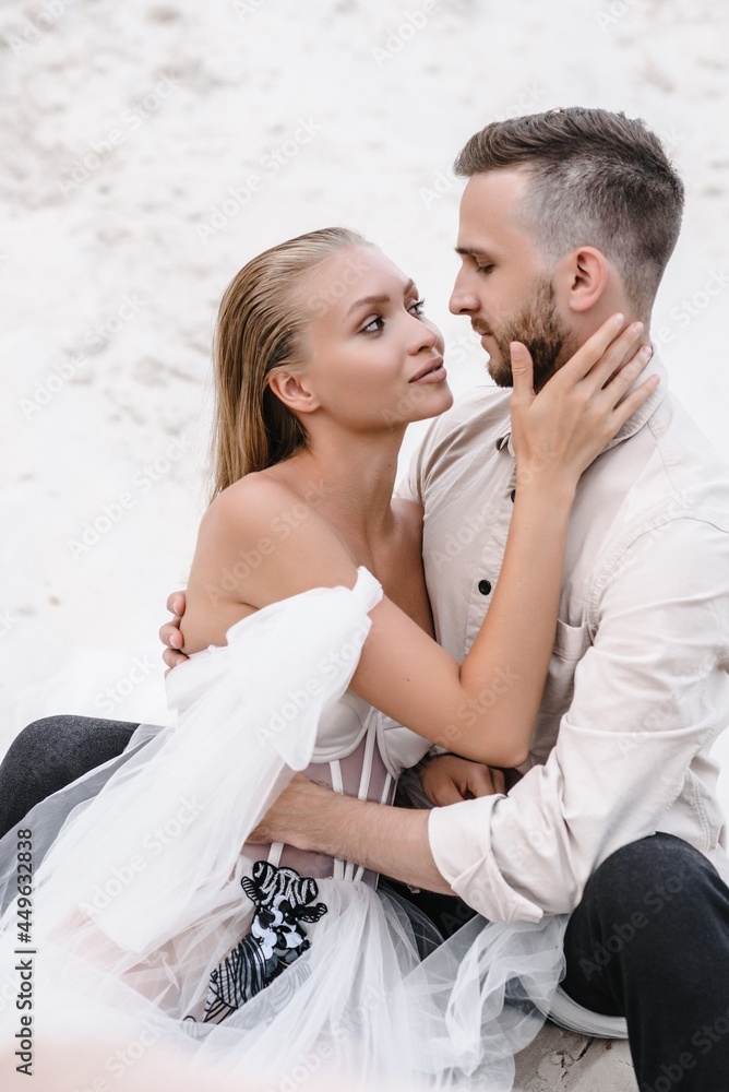 Beautiful wedding couple bride and groom at wedding day outdoors at ocean beach. Happy marriage couple o Beautiful wedding couple bride and groom at wedding day outdoors at ocean beach. Happy marriage couple o