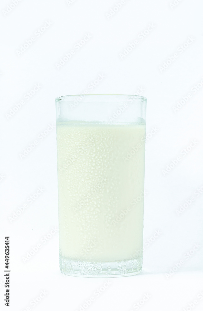 Image of isolated cool fresh milk in a clear glass containing water drop for a refreshing drink and healthy food on a white background with clipping path. Image of isolated cool fresh milk in a clear glass containing water drop for a refreshing drink and healthy food on a white background with clipping path.