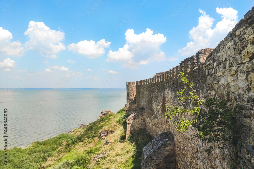 Medieval walls of a defensive castle overlooking the sea strait.
