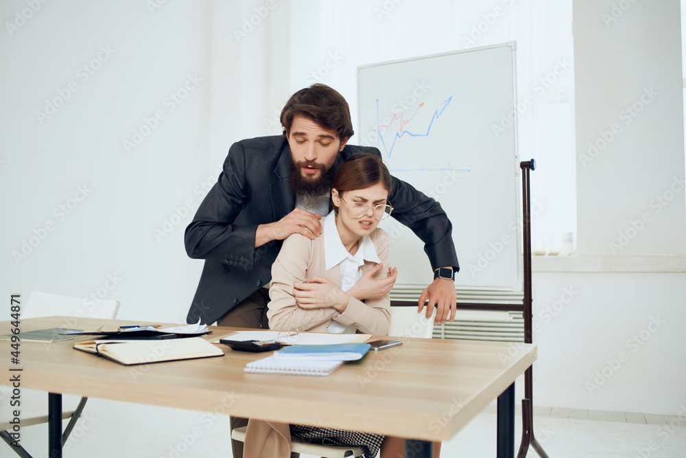 a man harasses a woman at work here harassment office work colleagues a man harasses a woman at work here harassment office work colleagues