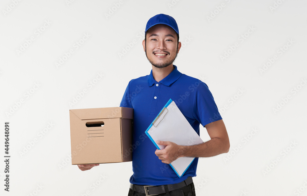 happy young asian delivery man holding clipboard and box isolated on white background. happy young asian delivery man holding clipboard and box isolated on white background.