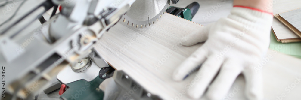 Master of flooring cuts daughter of the laminate on hand-held circular saw Master of flooring cuts daughter of the laminate on hand-held circular saw